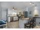 Well-lit kitchen with white cabinets, stainless steel appliances, and a breakfast bar with seating at 6000 N Ocean Blvd. # 133, North Myrtle Beach, SC 29582
