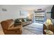 Comfortable living room with a beach-themed decor, sliding glass doors to a balcony, and cozy seating at 6000 N Ocean Blvd. # 133, North Myrtle Beach, SC 29582