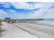 Scenic view of a wooden pier stretching over the sandy beach and into the ocean at 6000 N Ocean Blvd. # 133, North Myrtle Beach, SC 29582