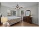 Comfortable bedroom with natural light, complemented by a wooden dresser and tasteful decor at 6001 - B7 S Kings Hwy., Myrtle Beach, SC 29575