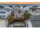 Charming coastal home with a large deck and palm trees, situated near a beautiful beach at sunset at 6001 - B7 S Kings Hwy., Myrtle Beach, SC 29575