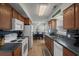 Well-lit kitchen featuring wooden cabinets and a dining area with black table and chairs at 6001 - B7 S Kings Hwy., Myrtle Beach, SC 29575