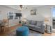 Bright living room offering a plush sofa, a blue ottoman, and view of the kitchen at 6001 - B7 S Kings Hwy., Myrtle Beach, SC 29575