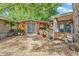 Charming backyard featuring small outbuildings, green spaces, a gravel area and mature trees at 6001-N73 South Kings Hwy., Myrtle Beach, SC 29575