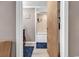 A bathroom featuring an open door showing the tiled shower and a sign that reads, 