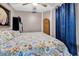 Bedroom with a sea-themed quilt, dark curtains, and a large wicker hamper at 6001-N73 South Kings Hwy., Myrtle Beach, SC 29575