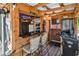 Outdoor cabana boasting a granite countertop bar, TVs, mini-fridge, bar seating, and a BBQ grill at 6001-N73 South Kings Hwy., Myrtle Beach, SC 29575