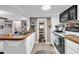 Bright kitchen showcasing wood countertops, white appliances, and a connecting living space at 6001-N73 South Kings Hwy., Myrtle Beach, SC 29575