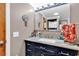 Updated vanity with marble countertop, updated fixtures, mirror, and views of the shower and laundry at 6001-N73 South Kings Hwy., Myrtle Beach, SC 29575
