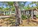 Exterior view of cottage, showcasing its quaint charm and surrounding yard at 6001-N74 South Kings Hwy., Myrtle Beach, SC 29575