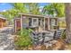 Exterior view featuring a small deck and cottage-style architecture with a red door at 6001-N74 South Kings Hwy., Myrtle Beach, SC 29575
