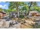 Exterior of a cozy cottage with a small porch, nestled among mature trees at 6001-N74 South Kings Hwy., Myrtle Beach, SC 29575
