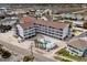 Aerial view of the building featuring a pool and nearby neighborhood at 625 N Waccamaw Dr. # 107, Murrells Inlet, SC 29576