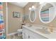 Bathroom with double sink vanity, two mirrors, and a coordinated color scheme at 625 N Waccamaw Dr. # 107, Murrells Inlet, SC 29576