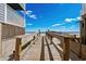 Wooden walkway offers direct access to the sandy beach with clear blue skies in the background at 625 N Waccamaw Dr. # 107, Murrells Inlet, SC 29576