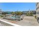 Community Pool with palm trees and blue umbrellas surrounded by condo buildings at 625 N Waccamaw Dr. # 107, Murrells Inlet, SC 29576