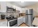 Modern kitchen featuring stainless steel appliances, granite countertops, and gray backsplash at 625 N Waccamaw Dr. # 107, Murrells Inlet, SC 29576