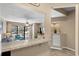 Kitchen bar with a view to the living room with balcony access at 625 N Waccamaw Dr. # 107, Murrells Inlet, SC 29576