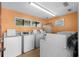 Clean and organized laundry room with multiple washing machines and a window at 625 N Waccamaw Dr. # 107, Murrells Inlet, SC 29576