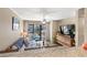 Cozy living room with natural light, a flat screen tv, and sliding glass doors to a deck at 625 N Waccamaw Dr. # 107, Murrells Inlet, SC 29576