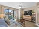 Cozy living room with a TV, modern decor and balcony access at 625 N Waccamaw Dr. # 107, Murrells Inlet, SC 29576
