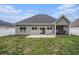 View of the home's backyard, patio, and screened-in porch with a well-kept lawn at 630 Heartwood Dr., Conway, SC 29526