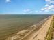 Expansive beachfront vista with a clear sky, gentle waves, and a mix of beachgoers enjoying the sandy shore at 630 Heartwood Dr., Conway, SC 29526