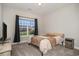 Comfortable bedroom featuring a neutral color scheme, carpet, and a window overlooking the neighborhood at 630 Heartwood Dr., Conway, SC 29526