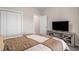 Bedroom featuring a TV, closet, and doorway with carpet and neutral colored walls at 630 Heartwood Dr., Conway, SC 29526