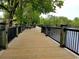 Picturesque wooden boardwalk with black railings offering tranquil views of the surrounding water and trees at 630 Heartwood Dr., Conway, SC 29526