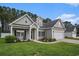 Charming home with a well-manicured lawn, lush landscaping, and a two-car garage at 630 Heartwood Dr., Conway, SC 29526