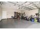 Spacious garage with epoxy flooring, overhead storage racks, and ample space for vehicles and projects at 630 Heartwood Dr., Conway, SC 29526
