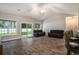 Large living room featuring hardwood floors, vaulted ceilings, and abundant natural light at 630 Heartwood Dr., Conway, SC 29526