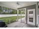 Relaxing screened porch offering a view of the backyard, with a ceiling fan and outdoor access at 630 Heartwood Dr., Conway, SC 29526