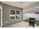 Cozy screened porch featuring a ceiling fan, view of the backyard, and an outdoor grill at 630 Heartwood Dr., Conway, SC 29526