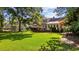 Lush green backyard with a swing set, mature trees, and a manicured lawn at 645 Boundary Line Dr. Nw, Calabash, NC 28467