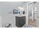 Bathroom with wainscoting, marble floors, and modern vanity with a framed mirror at 645 Boundary Line Dr. Nw, Calabash, NC 28467