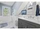 Renovated bathroom with wainscoting, marble floors, and modern vanity and lighting at 645 Boundary Line Dr. Nw, Calabash, NC 28467
