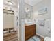 Charming bathroom boasts a wood vanity, modern sink, and stylish decor, complemented by wood-look floors at 645 Boundary Line Dr. Nw, Calabash, NC 28467