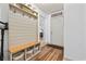 Inviting entryway features a shiplap accent wall with hooks and a built-in bench with storage baskets at 645 Boundary Line Dr. Nw, Calabash, NC 28467