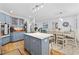 Spacious kitchen connects to dining area, featuring blue cabinets, a center island, and stainless steel appliances at 645 Boundary Line Dr. Nw, Calabash, NC 28467