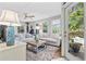 Cozy living room boasts comfortable white sofas, a ceiling fan, and access to outdoor spaces at 645 Boundary Line Dr. Nw, Calabash, NC 28467