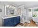 Charming main bathroom featuring a double sink vanity with marble countertops, a walk-in shower, and a stand alone tub at 645 Boundary Line Dr. Nw, Calabash, NC 28467