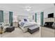 Light and airy main bedroom with neutral tones, ceiling fan, and a bench seat at the foot of the bed at 645 Boundary Line Dr. Nw, Calabash, NC 28467
