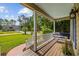 Inviting front porch with a swing, offering a relaxing view of the landscaped yard at 645 Boundary Line Dr. Nw, Calabash, NC 28467