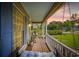 Cozy front porch with swing seating, and a view of the neighborhood and lush greenery at 645 Boundary Line Dr. Nw, Calabash, NC 28467