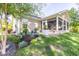 Landscaped backyard featuring a screened porch and well-maintained flower beds at 672 Ashley Manor Dr., Longs, SC 29568