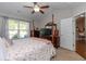 Comfortable bedroom featuring a ceiling fan and large windows overlooking the outdoor scenery at 672 Ashley Manor Dr., Longs, SC 29568