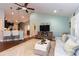 Spacious living room with a ceiling fan, a plush sofa, and a decorative rug at 672 Ashley Manor Dr., Longs, SC 29568