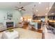 Open-concept living area with a fireplace, view into kitchen, hardwood floors, and plenty of space at 672 Ashley Manor Dr., Longs, SC 29568